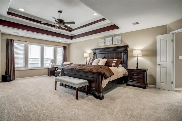bedroom with visible vents, carpet flooring, a raised ceiling, and baseboards