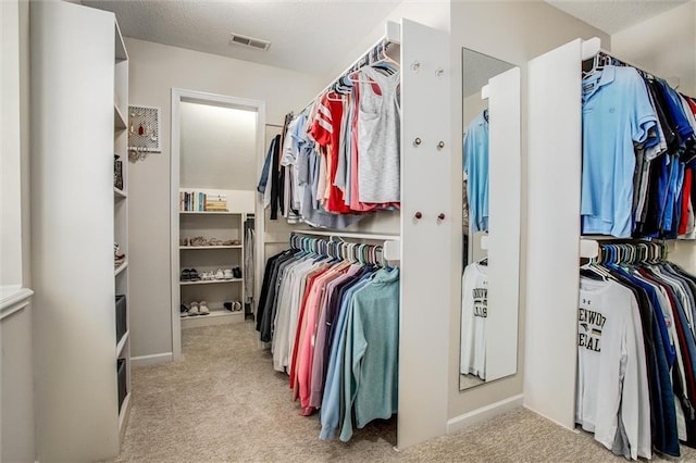 spacious closet with visible vents and carpet flooring