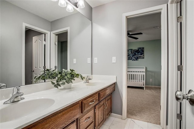 bathroom with double vanity, a sink, and baseboards