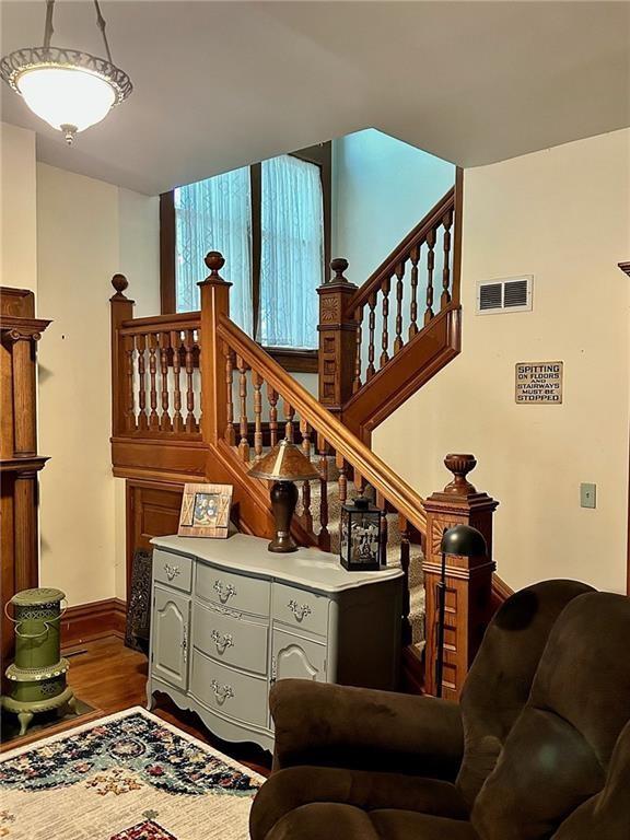 stairs featuring wood finished floors and baseboards