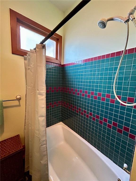 full bathroom with shower / bathtub combination with curtain