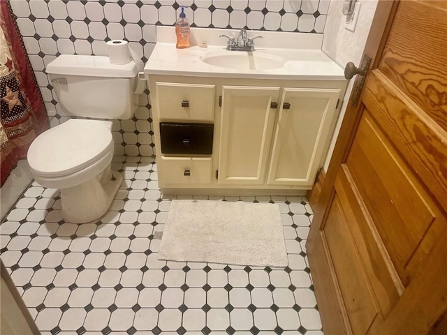 bathroom featuring tile patterned floors, vanity, and toilet