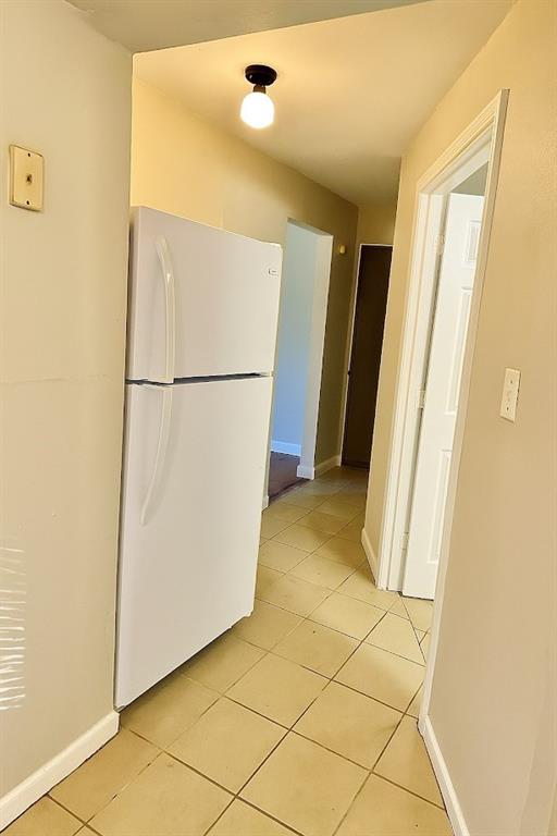5610 Euclid Ave, Kansas City, MO 64130 - kitchen featuring freestanding refrigerator and light tile patterned flooring
