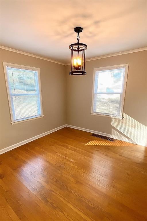 5610 Euclid Ave, Kansas City, MO 64130 - unfurnished room with ornamental molding and wood finished floors