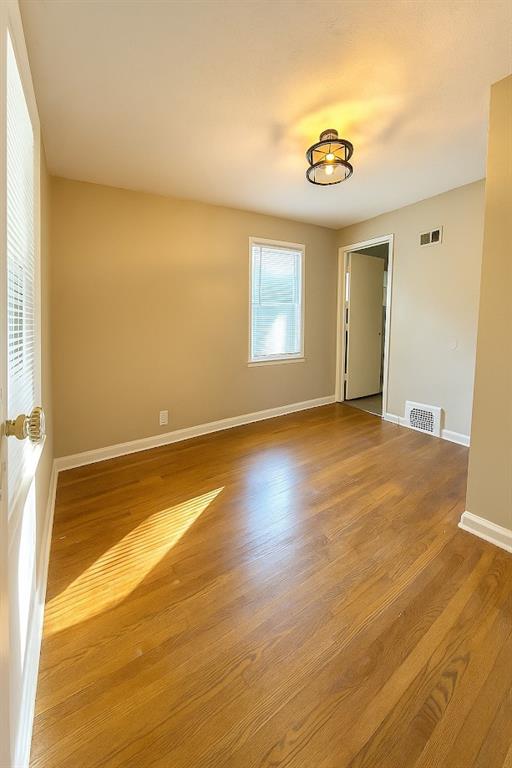 5610 Euclid Ave, Kansas City, MO 64130 - unfurnished room with wood finished floors and baseboards