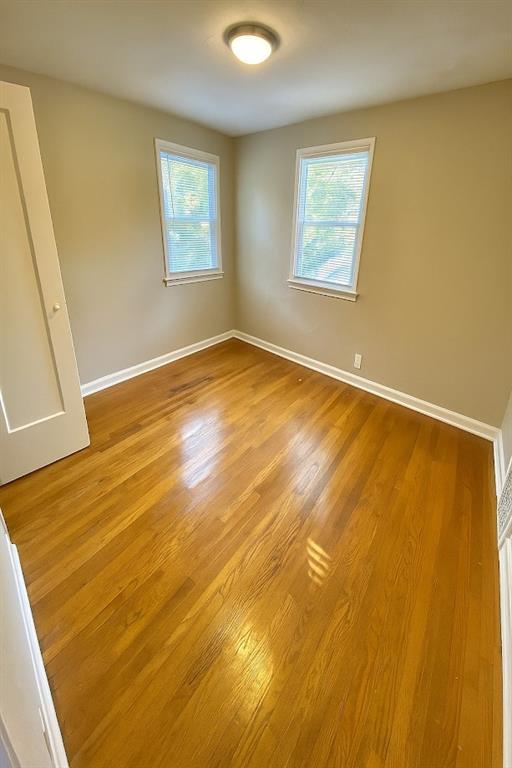 5610 Euclid Ave, Kansas City, MO 64130 - unfurnished room featuring wood finished floors and baseboards
