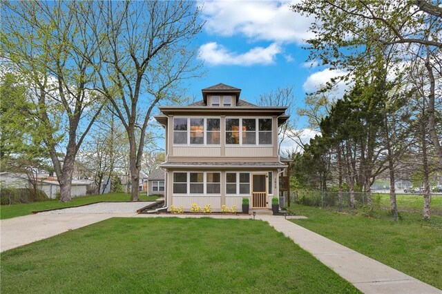 1610 S Northern Blvd, Independence, MO 64052 - traditional style home with fence, a front lawn, and a sunroom