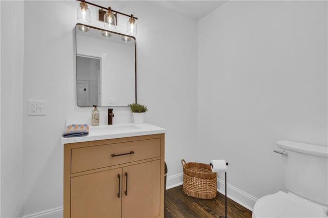 1610 S Northern Blvd, Independence, MO 64052 - half bath featuring toilet, vanity, wood finished floors, and baseboards