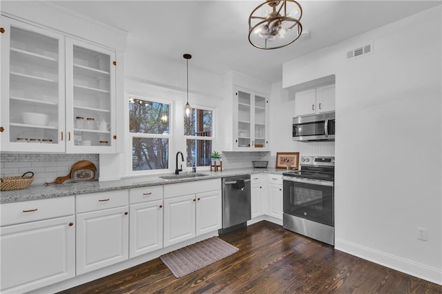 1610 S Northern Blvd, Independence, MO 64052 - kitchen featuring visible vents, a sink, backsplash, and appliances with stainless steel finishes