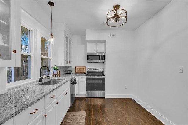 1610 S Northern Blvd, Independence, MO 64052 - kitchen featuring light stone counters, a sink, visible vents, appliances with stainless steel finishes, and dark wood-style floors