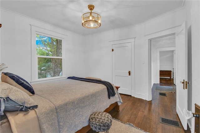 1610 S Northern Blvd, Independence, MO 64052 - bedroom featuring wood finished floors, visible vents, an inviting chandelier, and crown molding