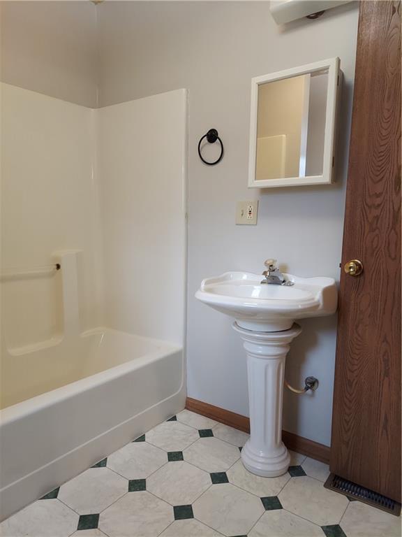 1610 S Northern Blvd, Independence, MO 64052 - full bathroom featuring baseboards, tile patterned floors, and bathing tub / shower combination