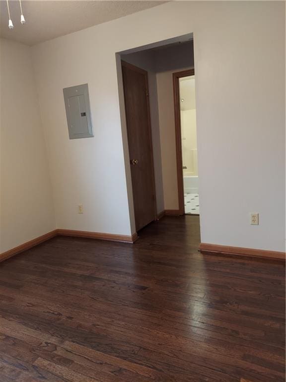 1610 S Northern Blvd, Independence, MO 64052 - unfurnished room featuring dark wood finished floors, baseboards, and electric panel