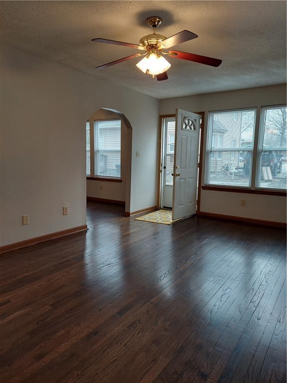 1610 S Northern Blvd, Independence, MO 64052 - interior space with arched walkways, plenty of natural light, a ceiling fan, and dark wood-style floors
