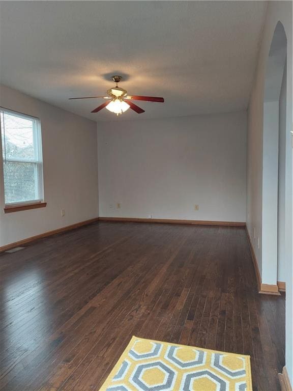 1610 S Northern Blvd, Independence, MO 64052 - unfurnished room with a ceiling fan, baseboards, and dark wood finished floors