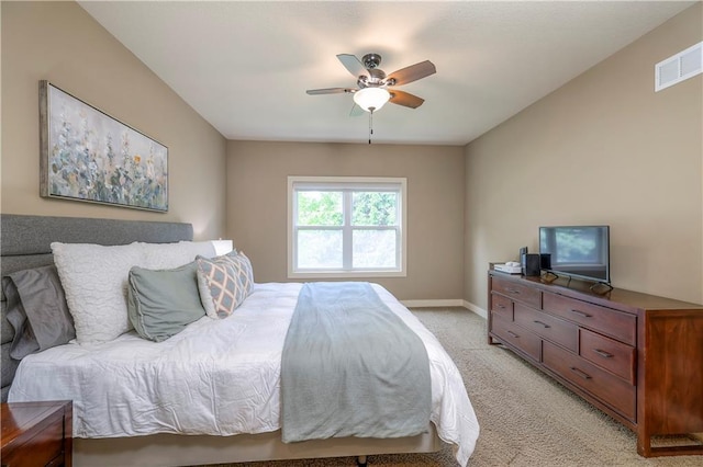 bedroom featuring baseboards, visible vents, light carpet, and ceiling fan