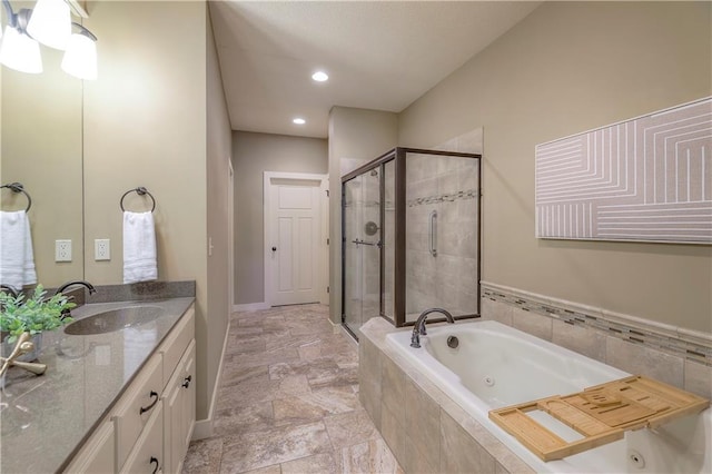 full bath with vanity, a whirlpool tub, a shower stall, and recessed lighting