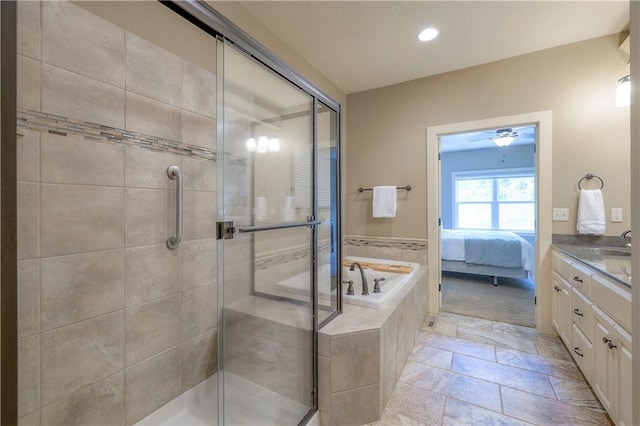 ensuite bathroom with recessed lighting, a shower stall, a garden tub, and vanity
