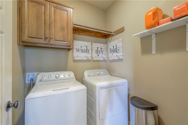 laundry area featuring cabinet space and washing machine and clothes dryer