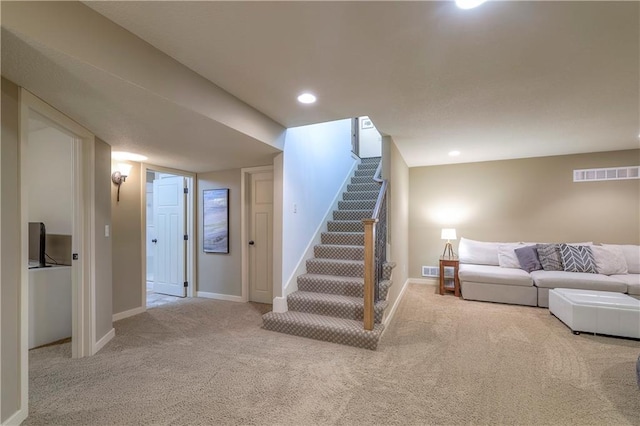 carpeted living area with stairs, recessed lighting, baseboards, and visible vents