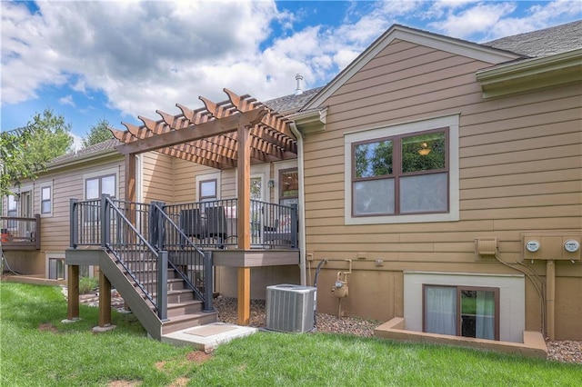 rear view of house featuring central AC, a pergola, a wooden deck, stairs, and a lawn