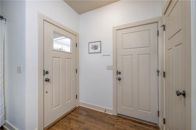 foyer entrance featuring dark wood-type flooring and baseboards