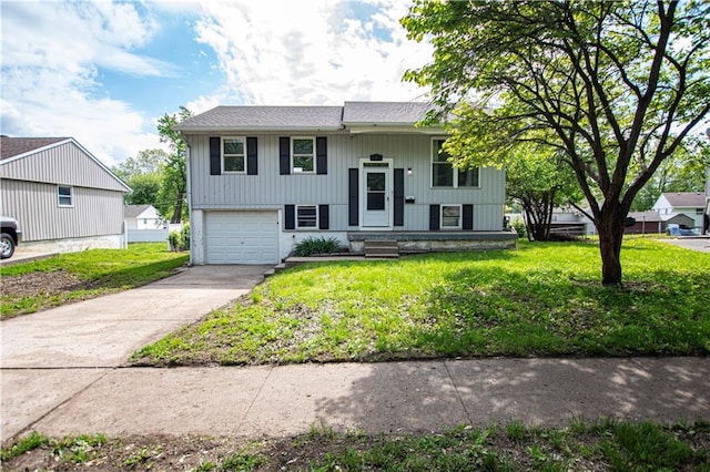 bi-level home with driveway, a garage, and a front yard