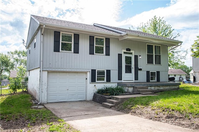 bi-level home featuring an attached garage, driveway, and a porch