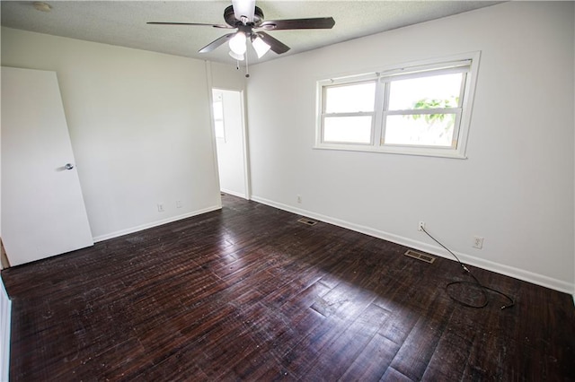 spare room with ceiling fan, baseboards, and wood finished floors