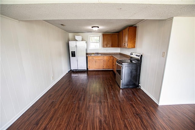 kitchen featuring stainless steel range with electric stovetop, refrigerator with ice dispenser, dark wood finished floors, a sink, and a textured ceiling