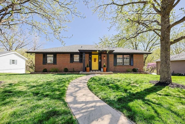ranch-style house featuring brick siding and a front lawn
