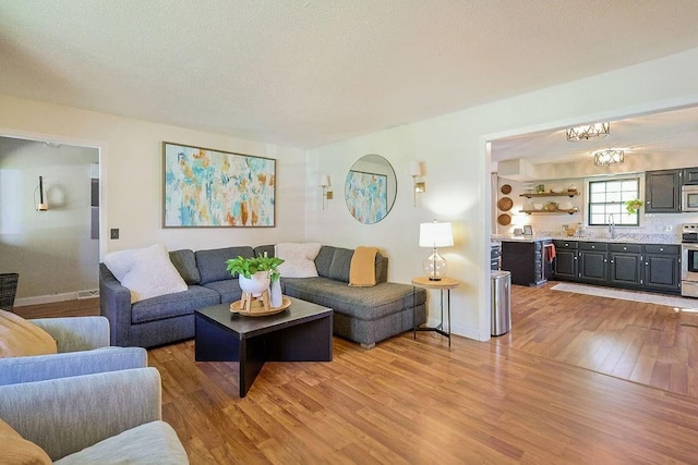 living room with light wood-type flooring and baseboards