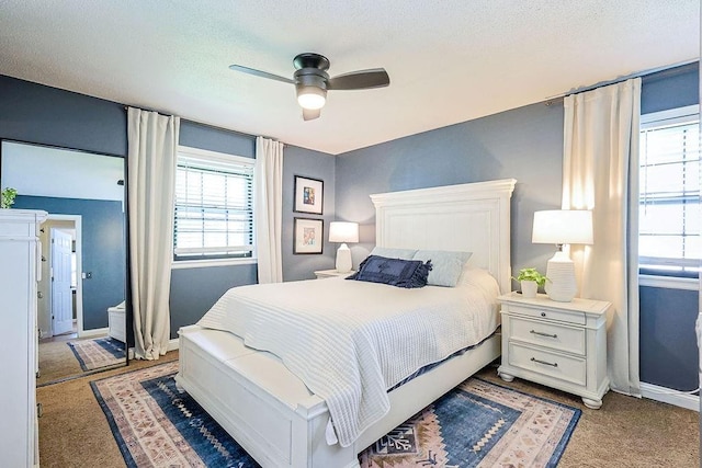 bedroom with light colored carpet, baseboards, and a ceiling fan