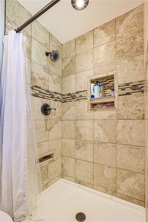 full bath featuring a shower stall