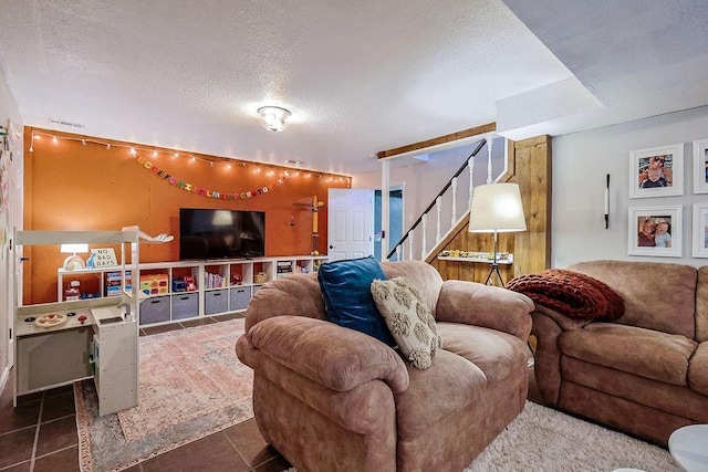 living room with a textured ceiling, stairs, and tile patterned flooring