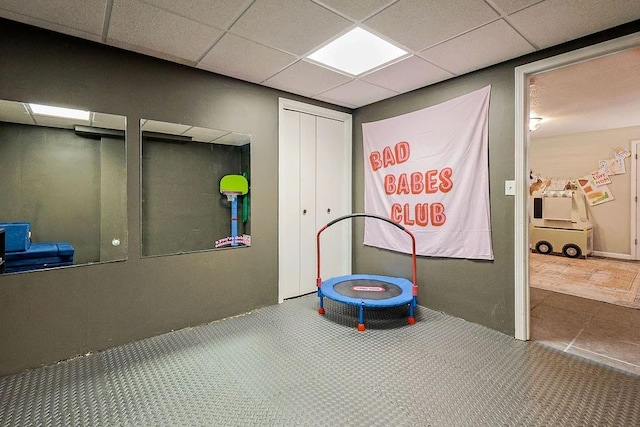 recreation room featuring a drop ceiling