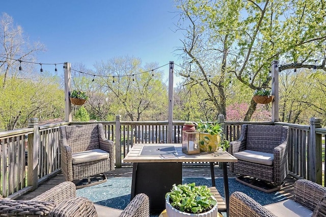 wooden terrace with an outdoor living space