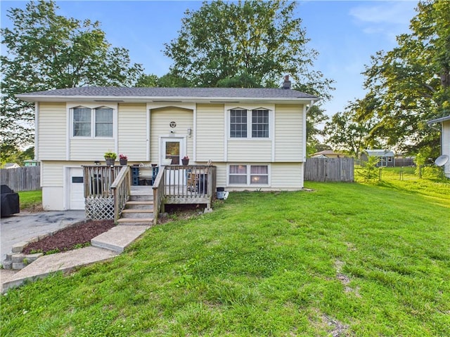 305 California Ave, Windsor, MO 65360 - bi-level home with a wooden deck, driveway, an attached garage, and a chimney