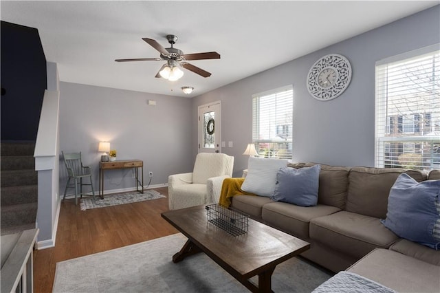 living area featuring baseboards, wood finished floors, and ceiling fan