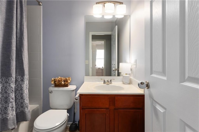 bathroom featuring shower / bath combination with curtain, toilet, and vanity