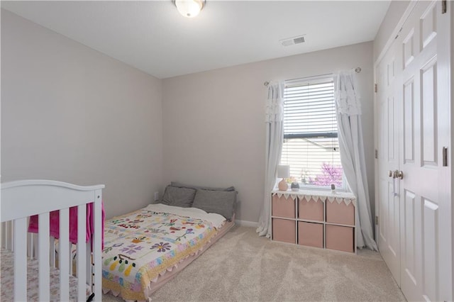 bedroom with visible vents and carpet flooring
