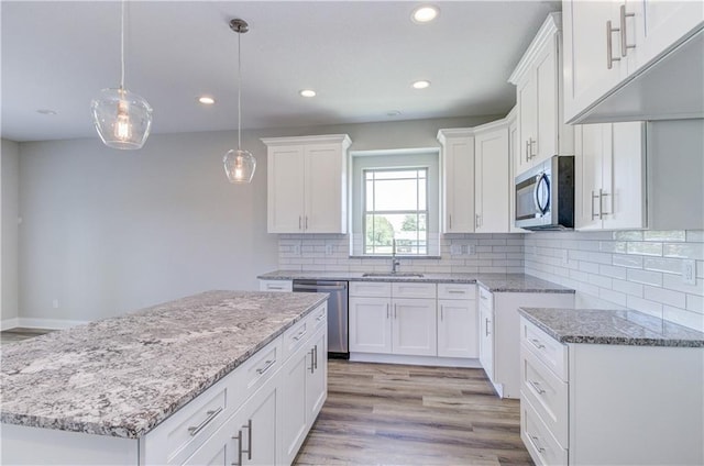 1828 N 92nd Ter, Kansas City, KS 66112 - kitchen with light stone counters, appliances with stainless steel finishes, a sink, and recessed lighting