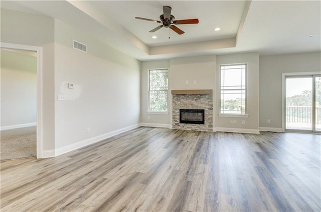 1828 N 92nd Ter, Kansas City, KS 66112 - unfurnished living room featuring baseboards, visible vents, ceiling fan, and a tray ceiling