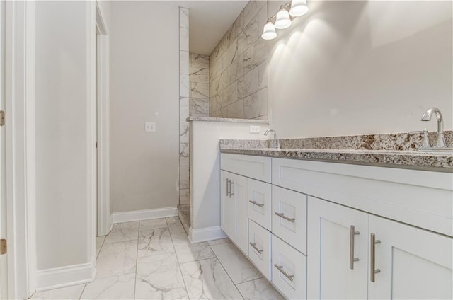 1828 N 92nd Ter, Kansas City, KS 66112 - bathroom with baseboards, marble finish floor, a sink, and double vanity