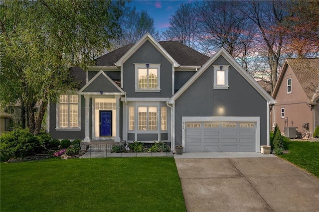 traditional-style house with stucco siding, central AC unit, driveway, and a front lawn