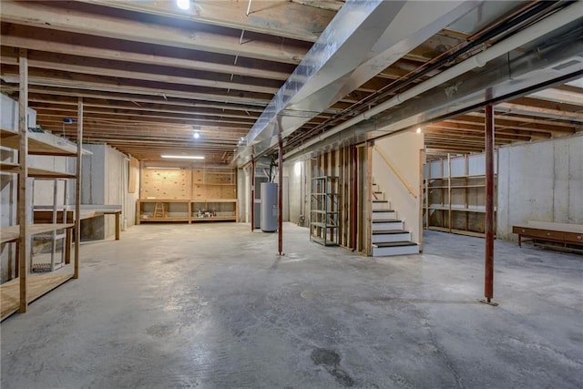 unfinished below grade area with water heater and stairway
