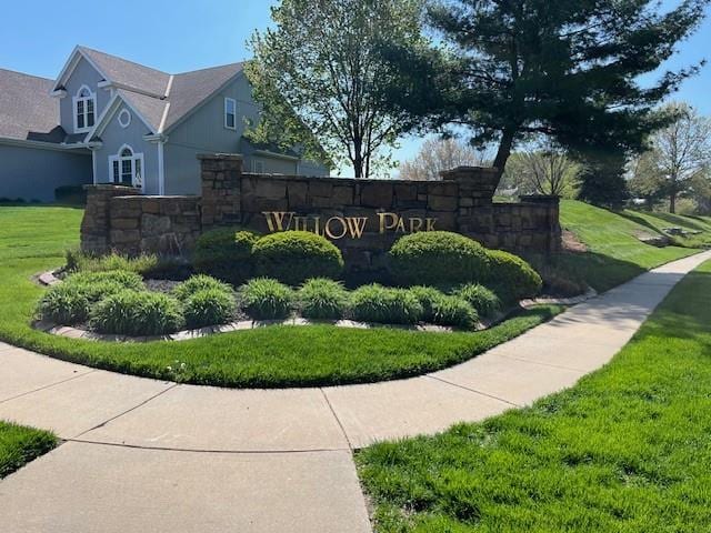 community sign featuring a lawn
