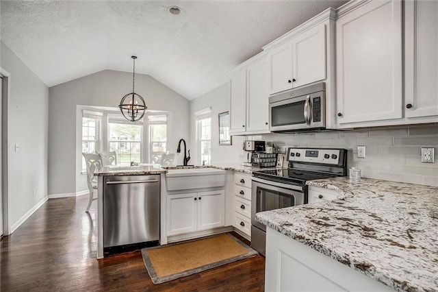 3204 SW Alice Ln, Lees Summit, MO 64082 - kitchen with an inviting chandelier, a peninsula, a sink, dark wood finished floors, and stainless steel appliances