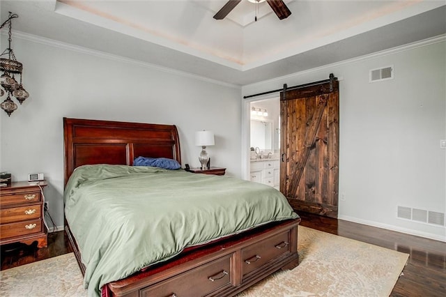 3204 SW Alice Ln, Lees Summit, MO 64082 - bedroom featuring a tray ceiling, wood finished floors, and visible vents