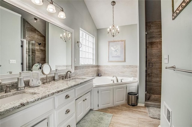 3204 SW Alice Ln, Lees Summit, MO 64082 - bathroom featuring a chandelier, a shower stall, a sink, and lofted ceiling